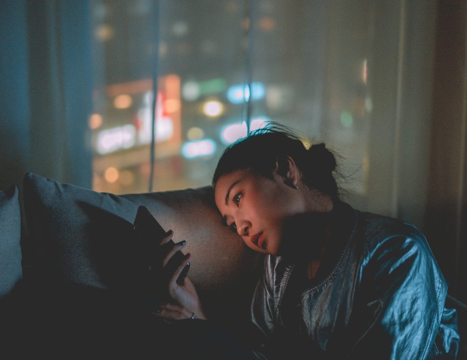 picture indicating Social Media Impact on Self-Esteem and Mental Health in Kenya as someone is seen scrolling at bedtime.